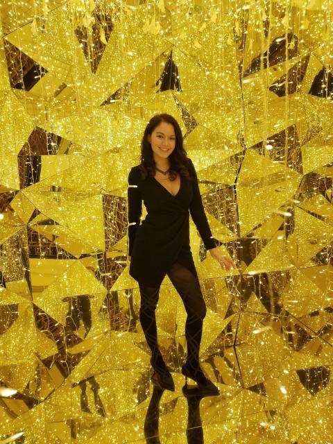 Fora Jenny Hart Travel Agent standing in front of yellow art display