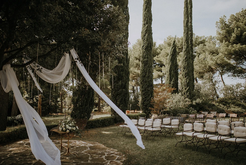 White chairs surrounded by gardens during daytime