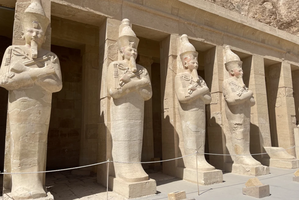 Large statues on side of building during daytime