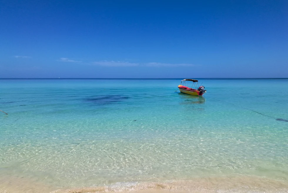 Boat sitting on the crystal clear water in Jamaica