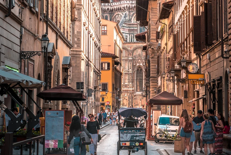 narrow busy city street with people shopping 