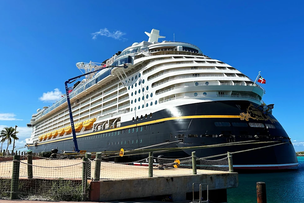 Disney cruise ship at port on a sunny day.