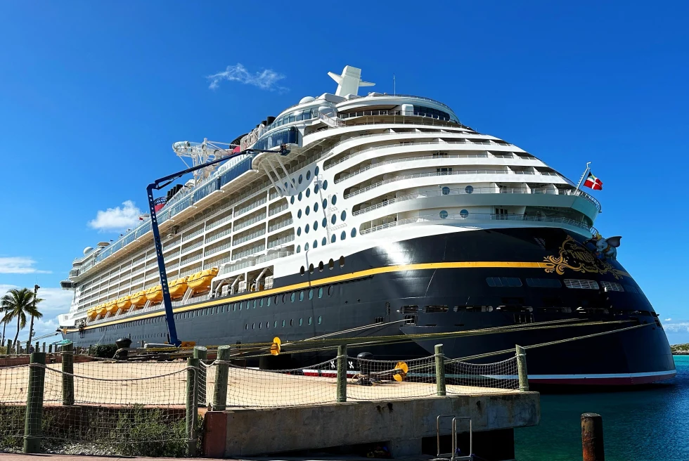 Disney cruise ship at port on a sunny day.