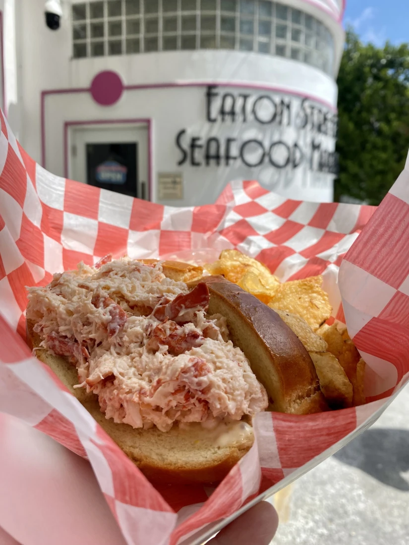 a lobster roll in red-and-white checkered paper