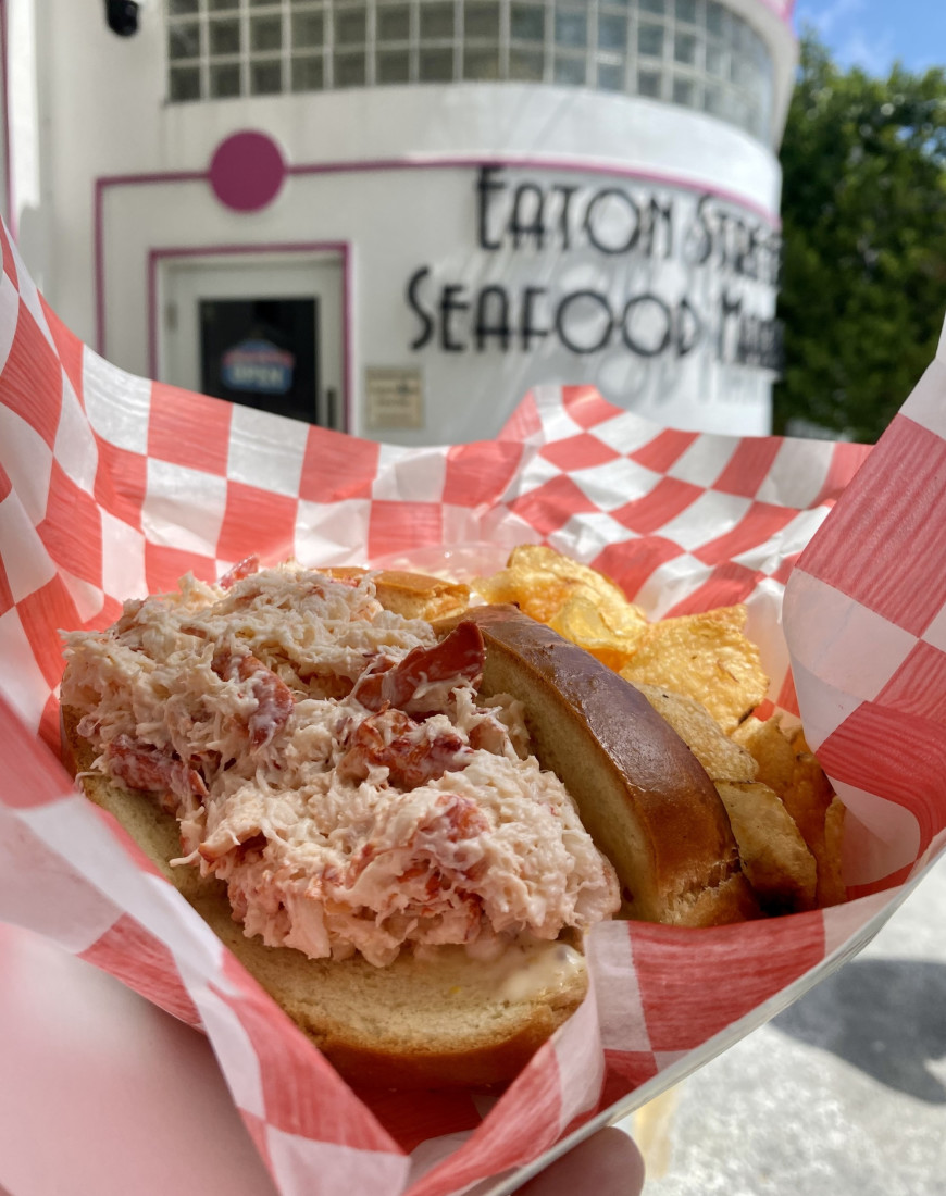 a lobster roll in red-and-white checkered paper