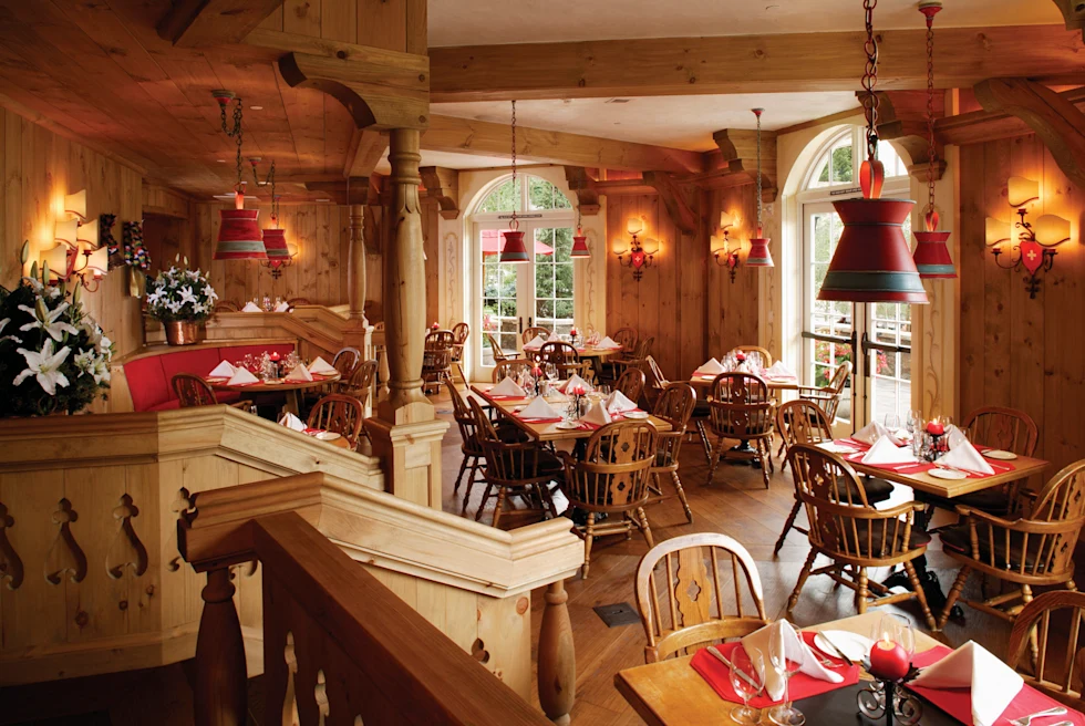 wooden chairs and tables with red placemats