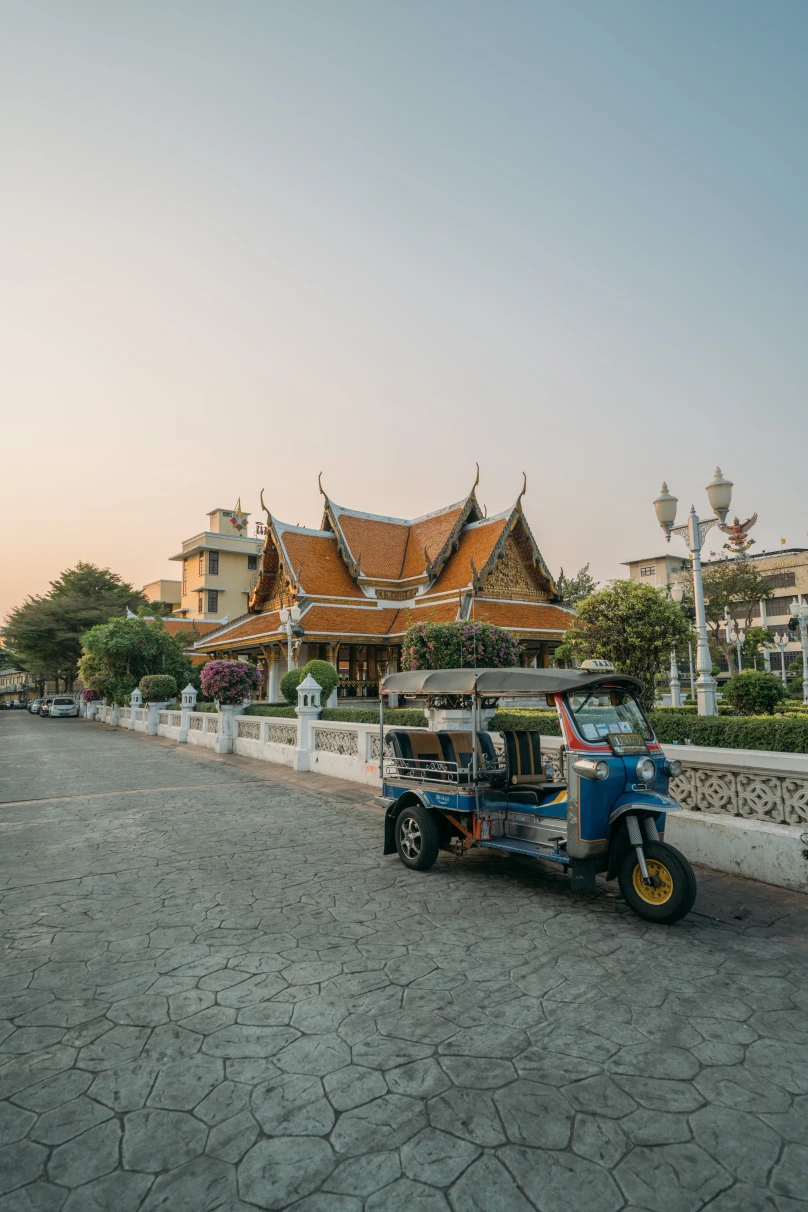 tuk tuk on the street with temple in the background