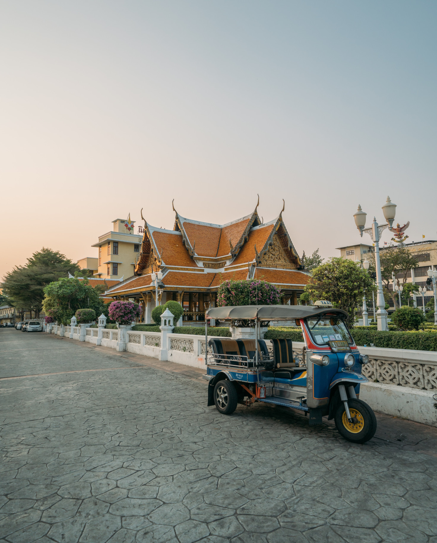 tuk tuk on the street with temple in the background
