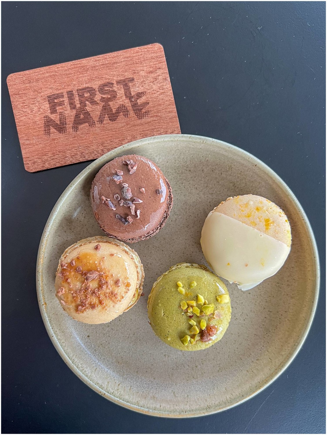 An overview of a plate of four pastries and a card that says "FirstName."