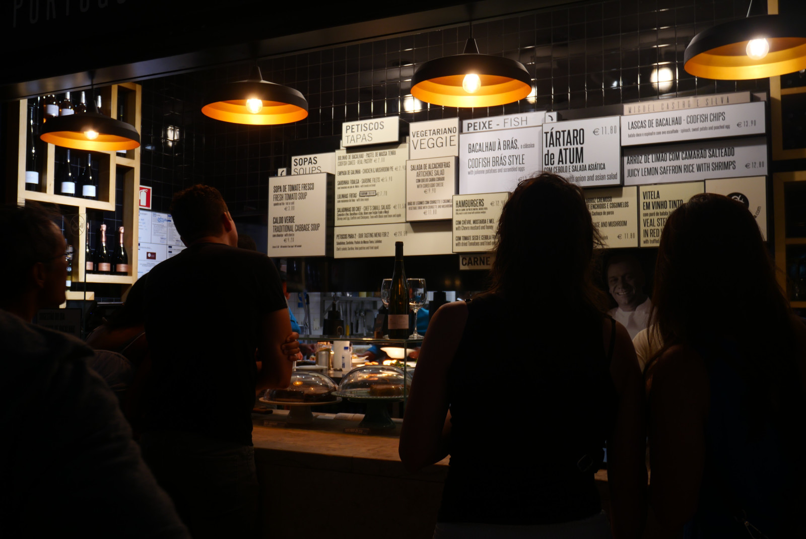 people standing at cafe counter