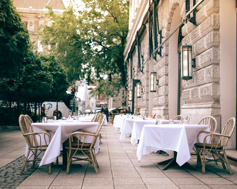 tables with white tablecloths outside