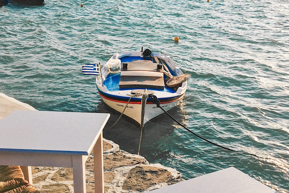 Boat in body of water next to houses during daytime