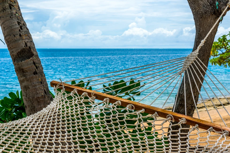 Blue sea and hammock on a beach.
