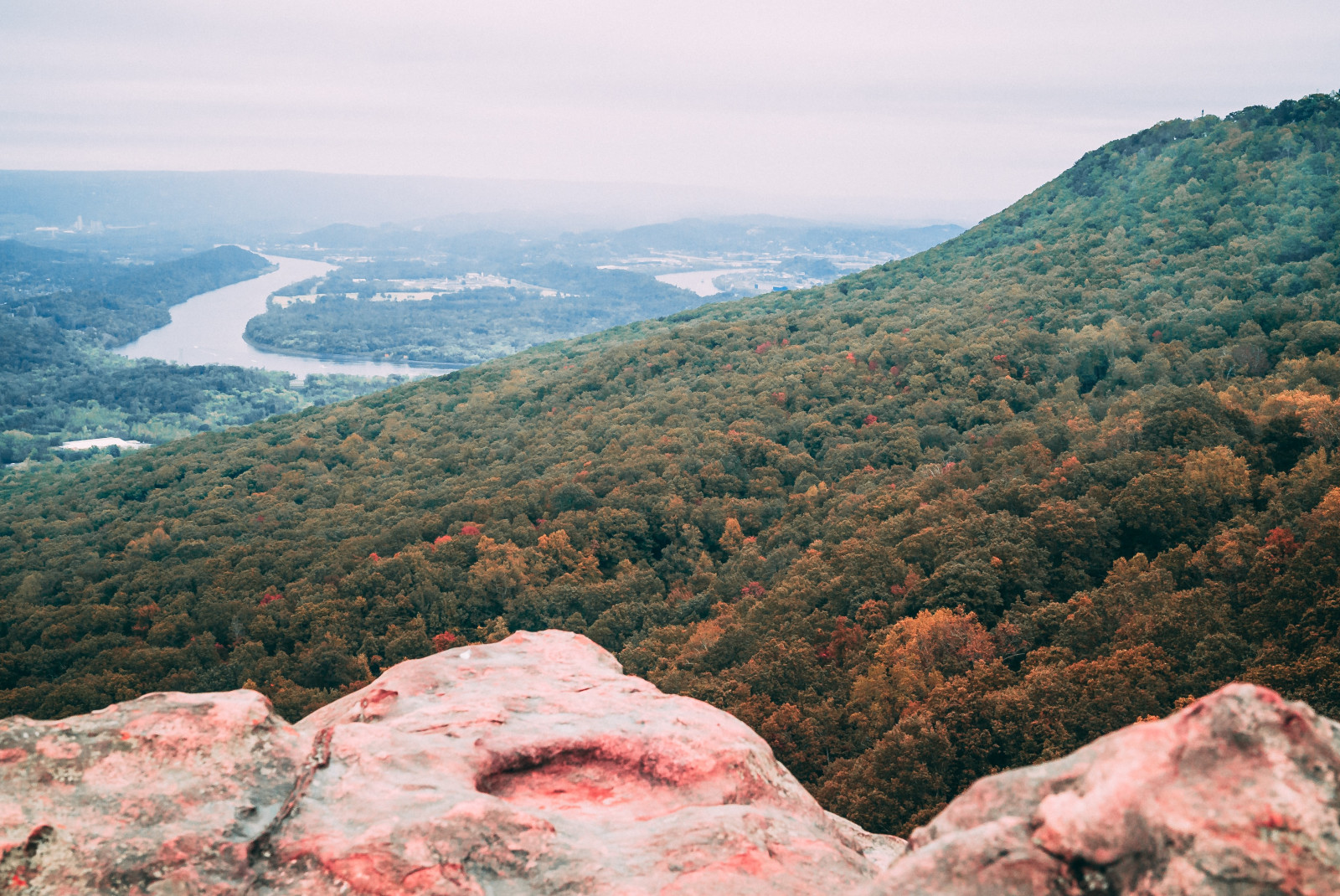 View from the top of a mountain in Chattanooga, Tennessee overlooking a river and hills dotted with green trees