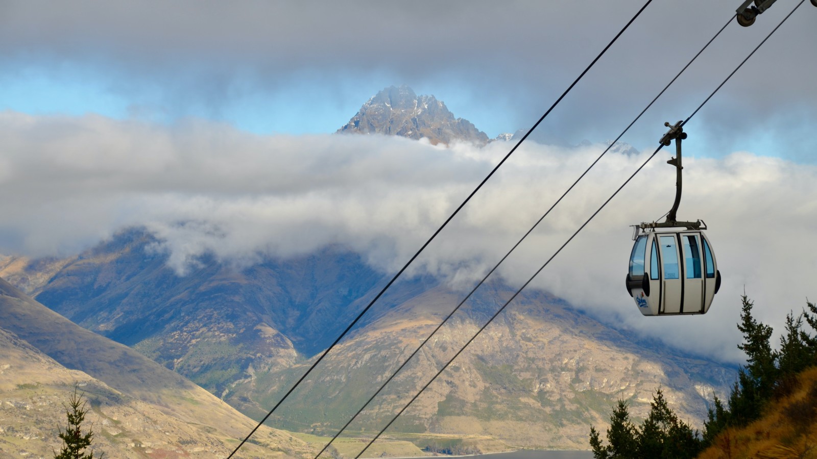 Gondola with mountains and clouds in Queenstown, NZ