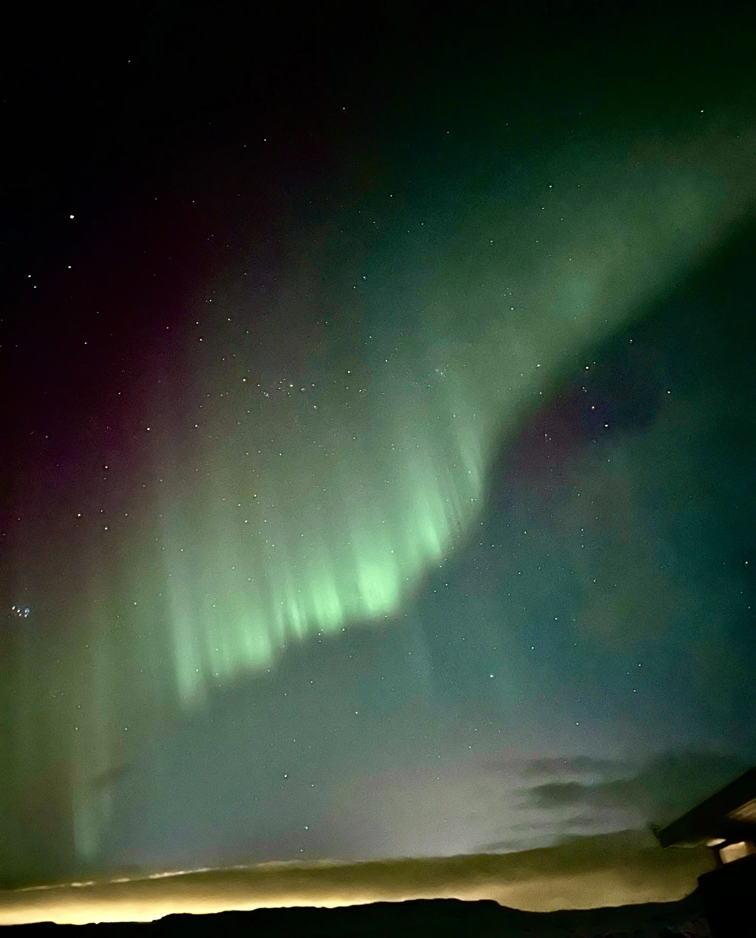 the green northern lights amidst starry skye