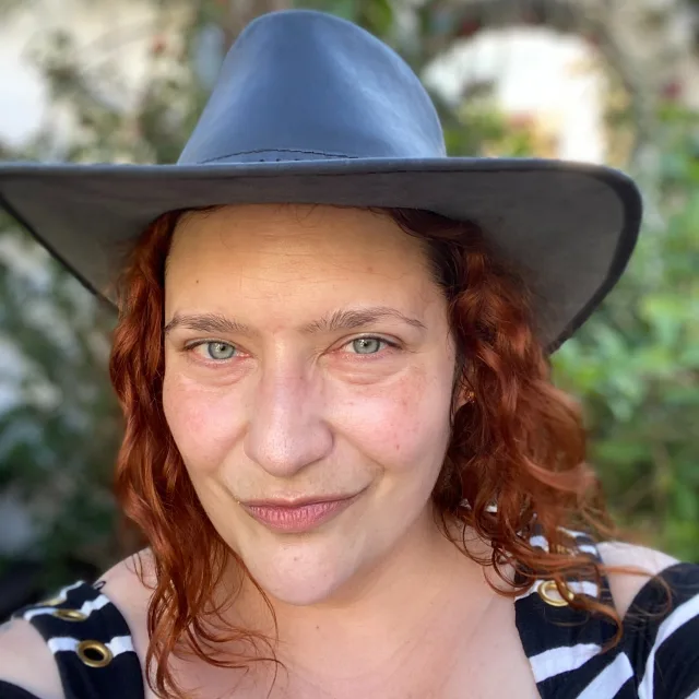Travel advisor Jenny Engard smiling in a selfie wearing black hat.