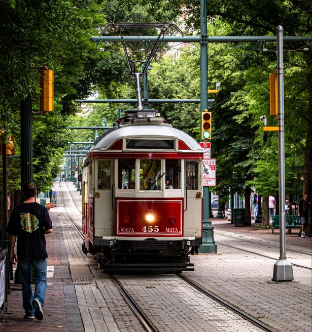 red trolley car on the street during daytime