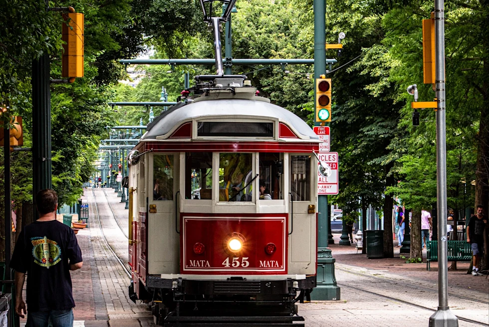 red trolley car on the street during daytime