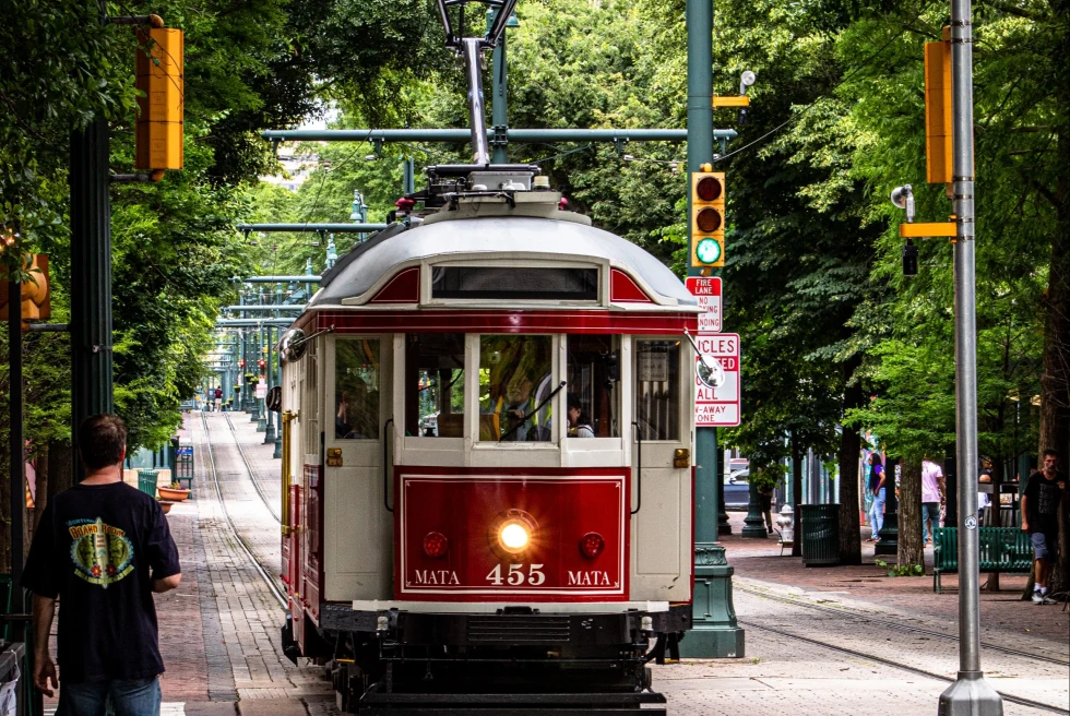 red trolley car on the street during daytime