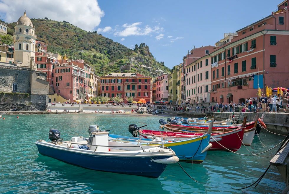 Colorful boats in water in Cinque Terre.