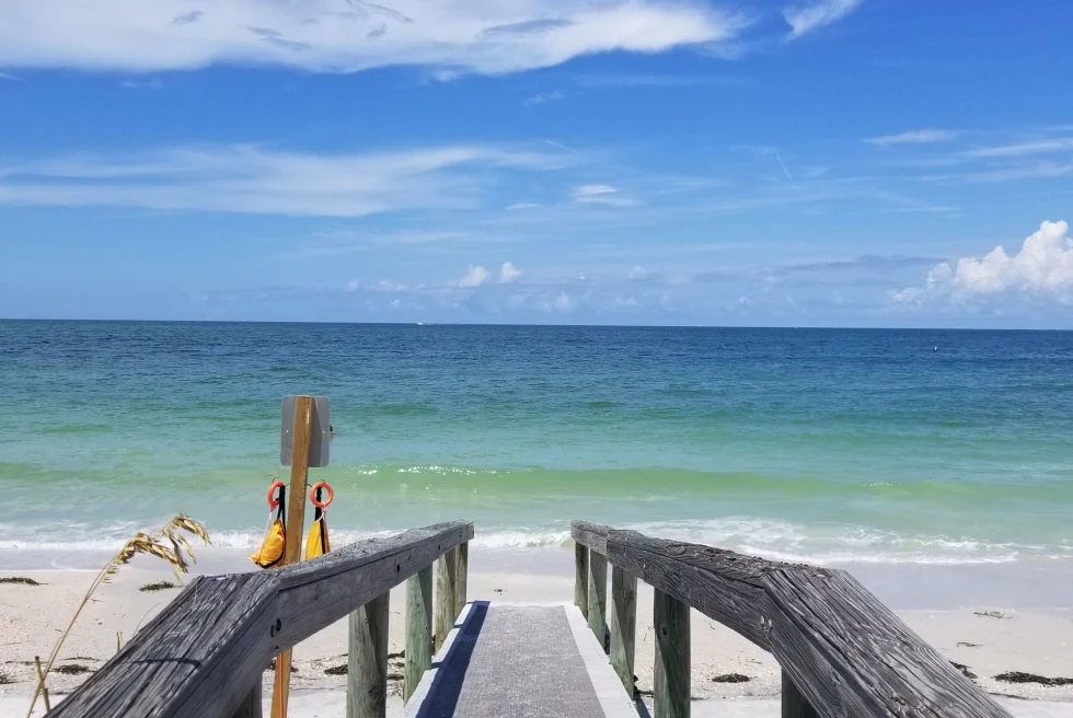 a boardwalk leads to the sandy ocean