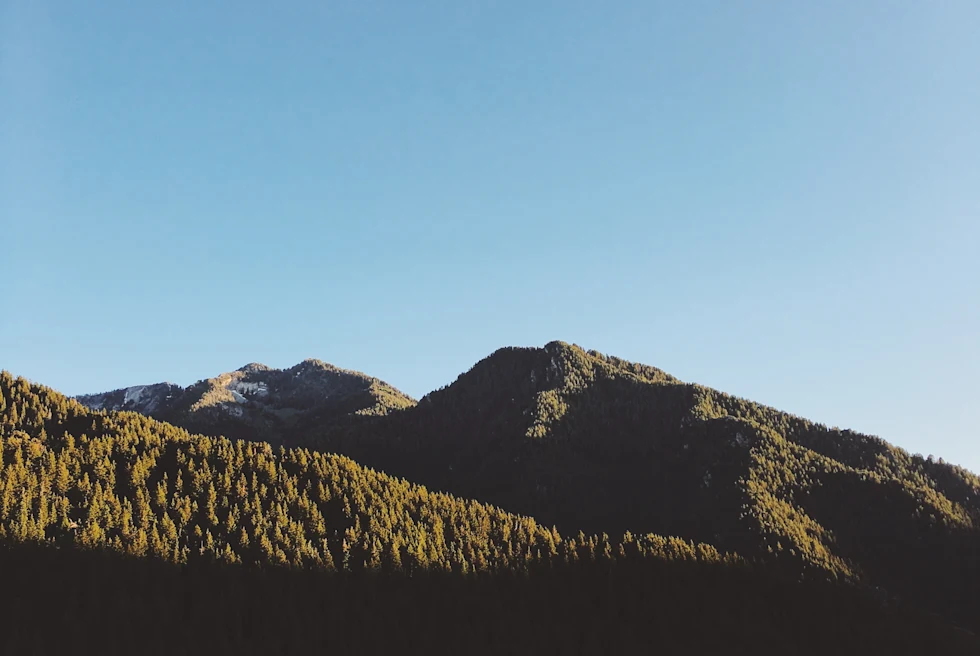 large green mountain with blue skies