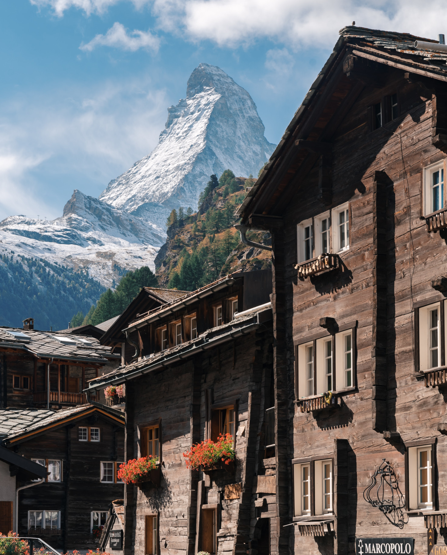 wood houses with mountains in the background during daytime