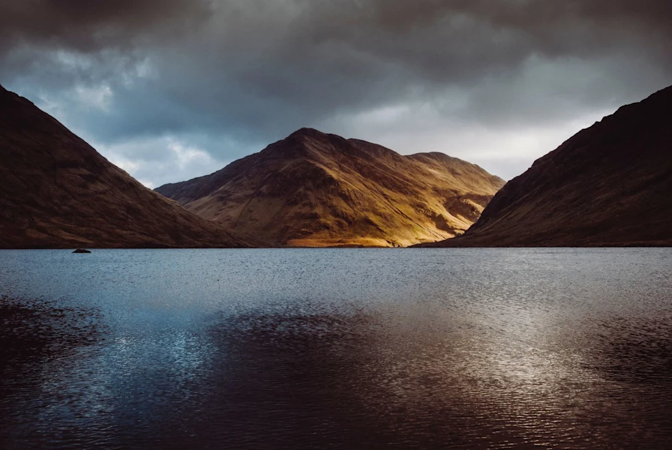 mountain region on the water at overcast