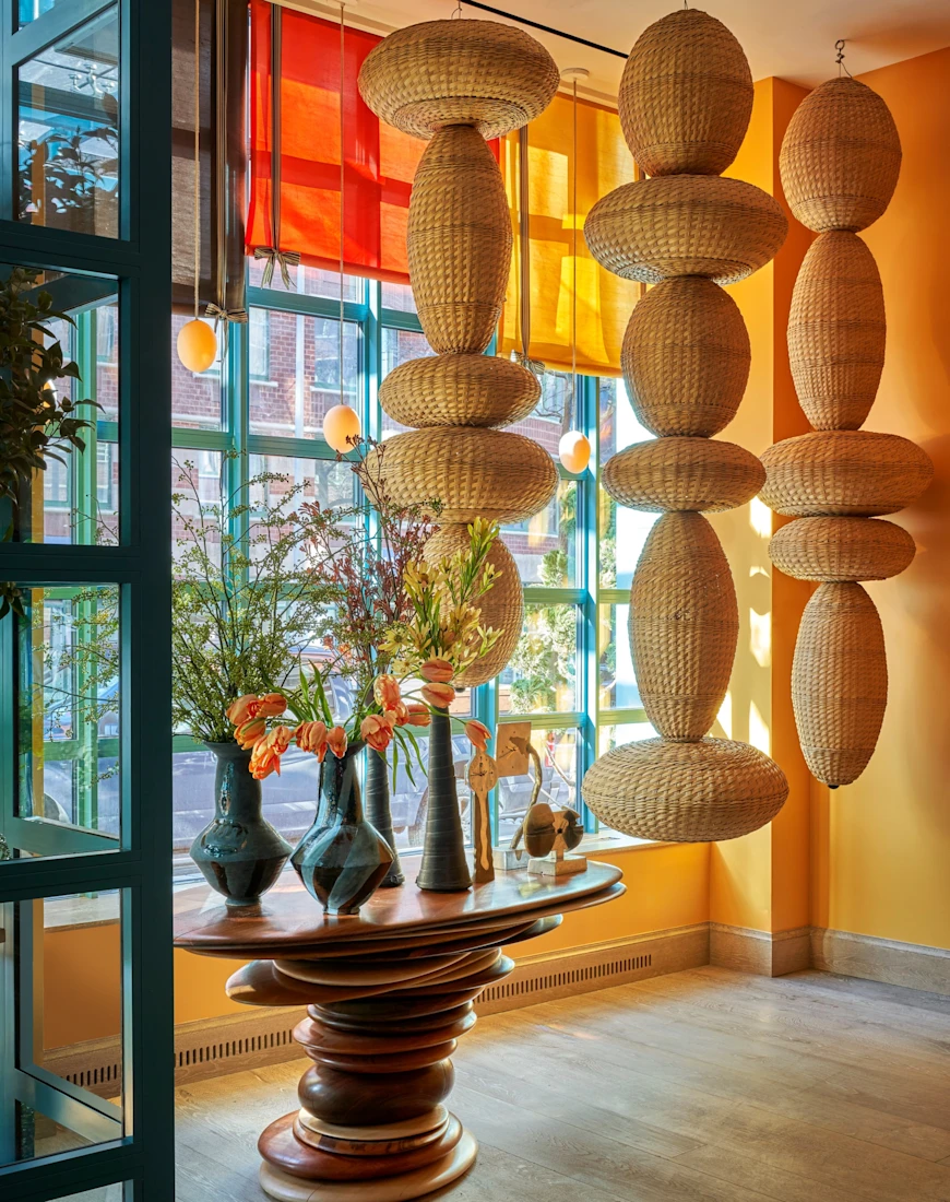 circular sculptures hang from the ceiling in a colorful entryway