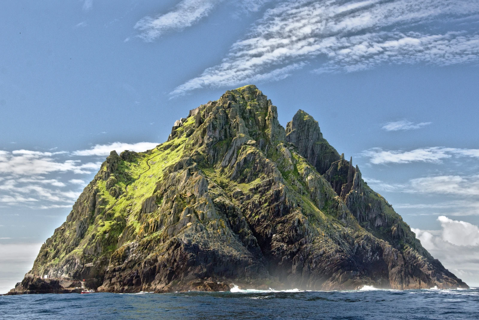 A green rugged island in the Atlantic Ocean. 