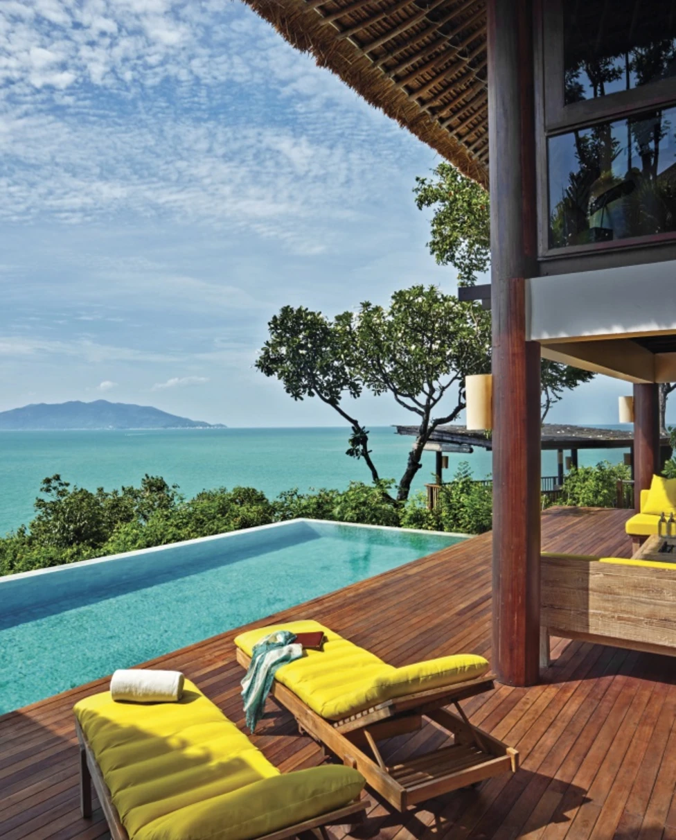 two yellow chairs on deck next to pool during daytime