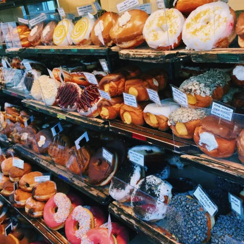 Pastries on shelves in a bakery.