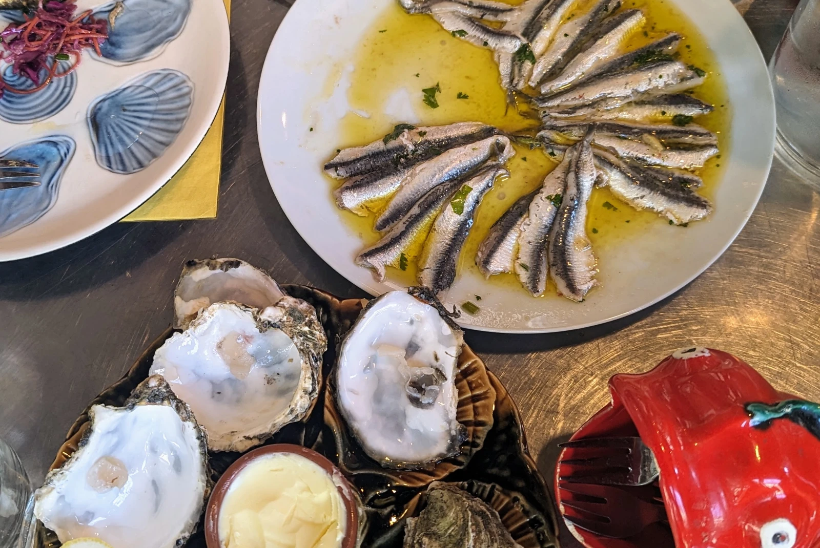 Dishes with oysters and other fish. 