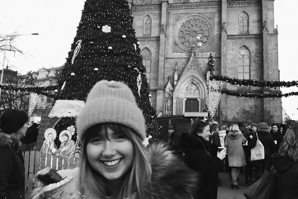 A girl standing in front of a building