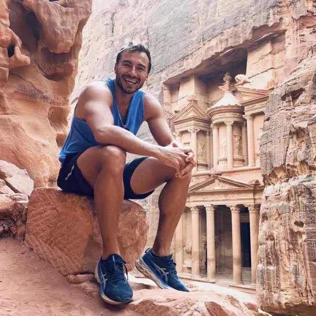 Travel Advisor Vincent Spieler in blue workout gear in front of Petra in Jordan.