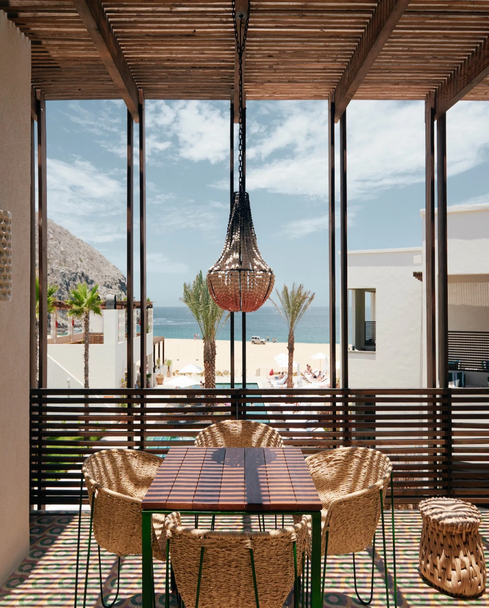 table and chairs on a terrace overlooking the beach