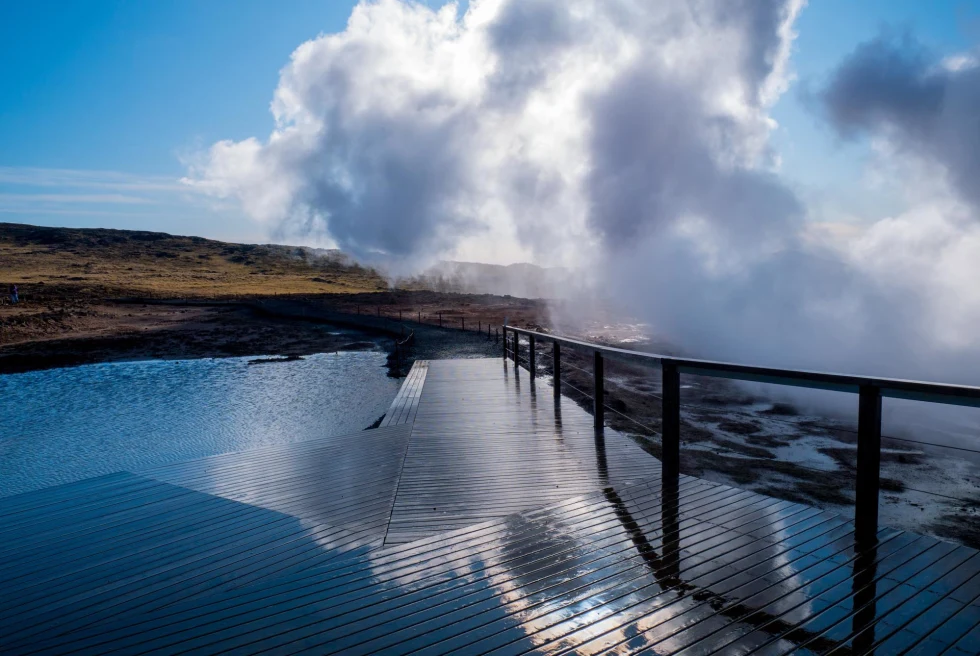 geothermal bath with wooden deck with steam rising from the water 