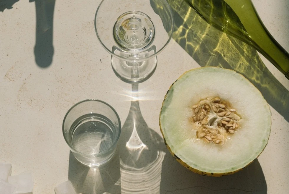 aerial view of half of a green melon near cocktail glasses