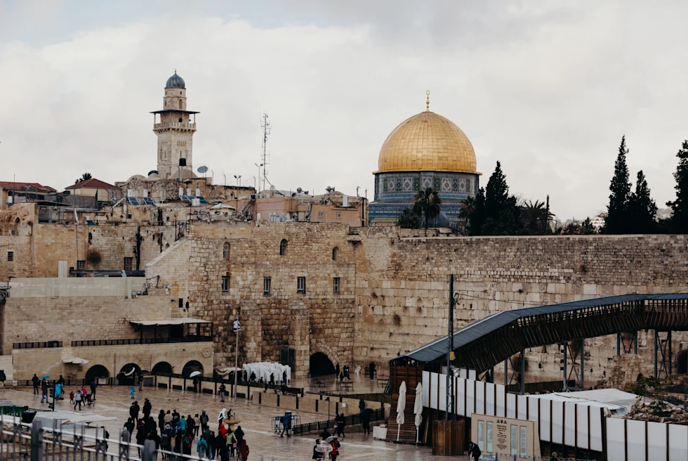 stone wall with gold dome in the background
