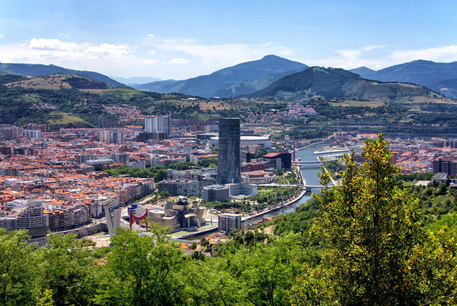 View of buildings and houses with mountains in the background in Bilbao, Spain 