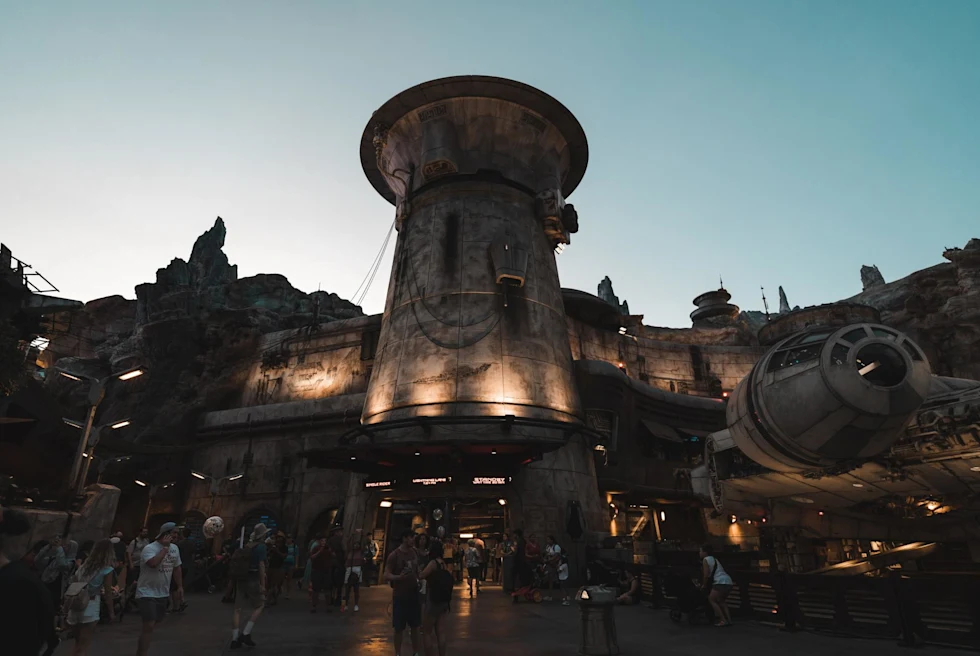 a large otherworldly fortress lit up at nightfall