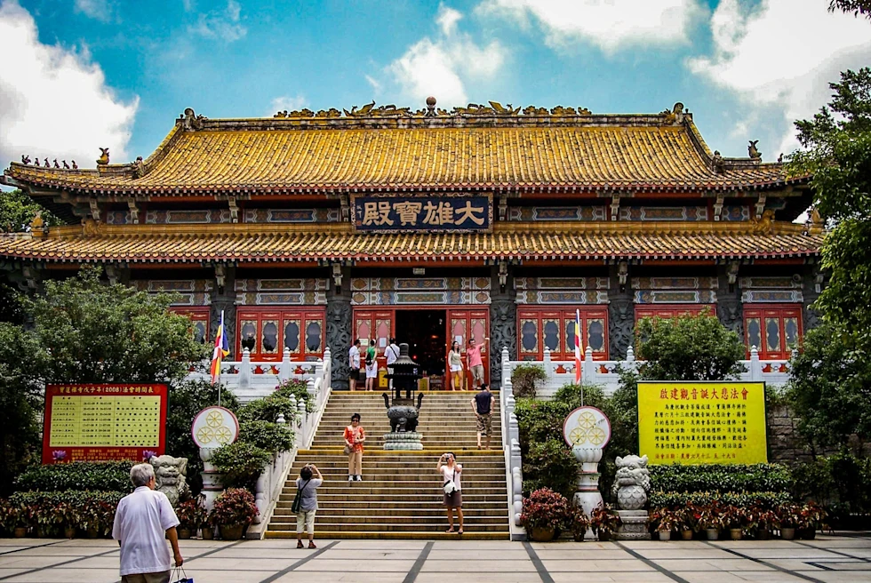 As Asian style building with stairs and people.