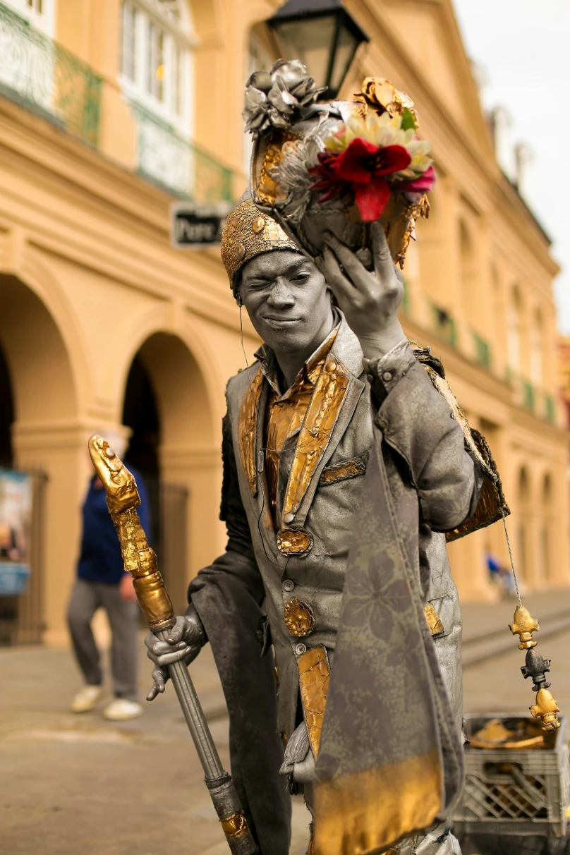 A person posing as a statue holding a bouquet of flowers