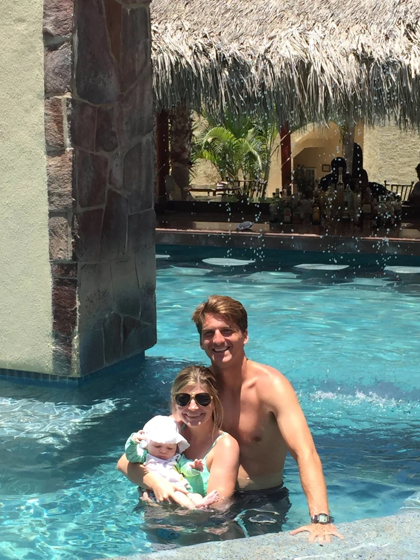 Travel advisor Jena Krinock with partner and baby in pool at Misiones del Cabo