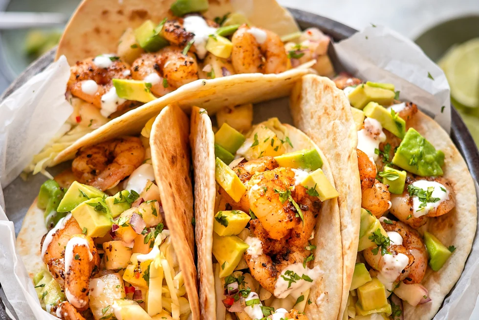 Person holds plate on tacos