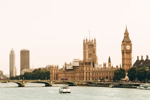 A sepia-tone view of Big Ben, London's Parliament Building, across from the River Thames.