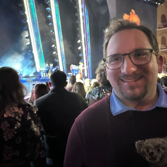 Travel advisor david magnotta stands in the audience at concert 