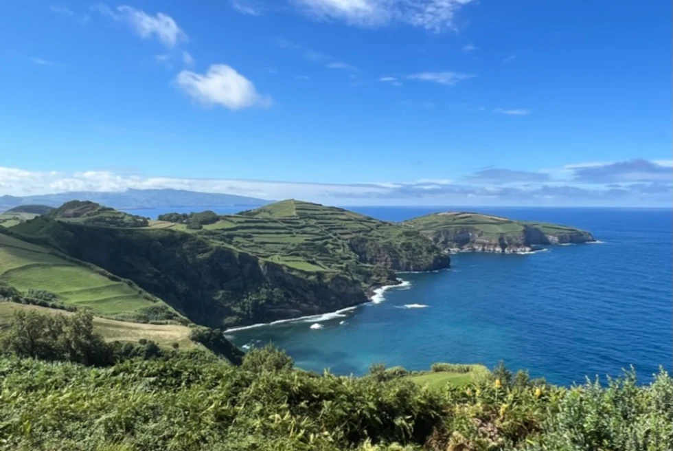 green blue water on the coast of an island with blue sky