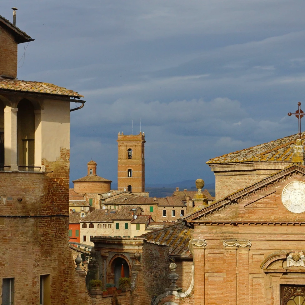 Skyline with tower in old city of Siena, Tuscany in Italy on a cloudy day.
